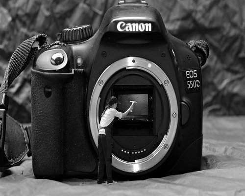 A clean desk set up against a wall with indirect natural light coming from the side